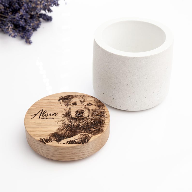 Concrete cat urn with oak cover and engraved pet photo.