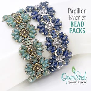 May include: Two beaded bracelets with a floral design. One bracelet features teal and gold beads, while the other has blue and silver beads. The bracelets are labeled "Papillon Bracelet BEAD PACKS".