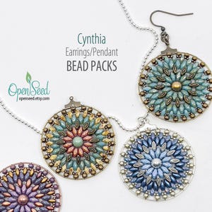 May include: Close-up of four beaded pendants and earrings in various colors, including blue, teal, and gold. The jewelry is circular with intricate beadwork. The text "Cynthia Earrings/Pendant BEAD PACKS" is visible.