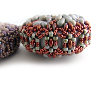 May include: Two beaded jewelry pieces, one with a brown and purple color scheme and the other with a green, brown, and white color scheme.