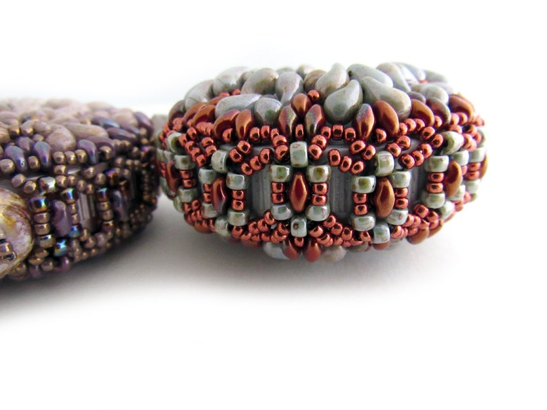 May include: Two beaded jewelry pieces, one with a brown and purple color scheme and the other with a green, brown, and white color scheme.