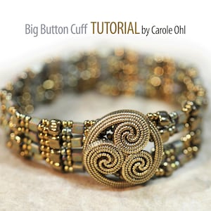 May include: A gold beaded bracelet with a large, ornate, gold button in the center. The button has a triple spiral design. The bracelet is made with a variety of gold beads, including round, square, and rectangular beads.