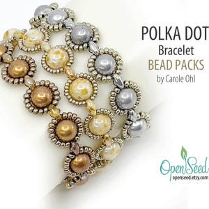 May include: Polka Dot Bracelet Bead Packs by Carole Ohl. A close-up of a multi-strand bracelet with gold, silver, and cream colored beads.