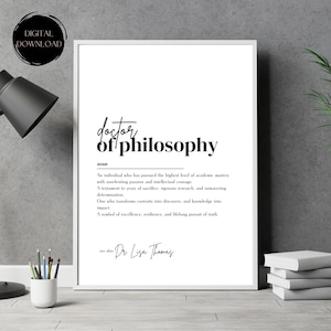 Puede incluir: Impresión enmarcada con la frase "doctor of philosophy" en negro, junto con una definición. La impresión también incluye el texto "Dr. Lisa Thomas" y "DIGITAL DOWNLOAD" en un diseño minimalista.