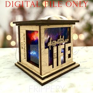 May include: A wooden lantern with the words "911 DISPATCHER LIFE" cut out. The lantern has a dark brown frame and a light brown body. The background inside the lantern is a colorful galaxy design. The text "DIGITAL FILE ONLY" is at the top.