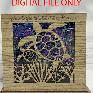 May include: Wooden laser-cut art piece featuring a sea turtle design. The artwork has a light brown frame with the words "Just Go With the Flow" and "DIGITAL FILE ONLY" etched into the wood. The turtle design is filled with a colorful underwater scene.
