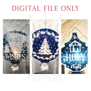 May include: Three decorative night lights with winter and holiday themes. One features a winter scene with the text "Warm Winter Wishes." Another has a Christmas tree design. The third depicts a nativity scene with the words "Holy Night."