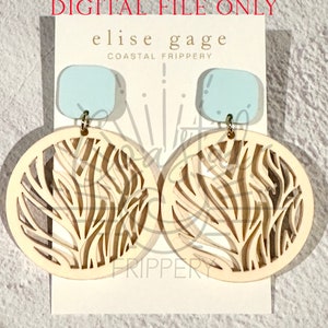 May include: A pair of dangle earrings with a light blue square top and a large, cream-colored circular pendant. The pendant features a cut-out design resembling a natural pattern. The earrings are attached to a white card with the text "elise gage COASTAL FRIPPERY".