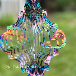 May include: A colorful, multi-layered, geometric wind spinner with a tie-dye pattern. The spinner is made of acrylic and has a clear, reflective surface. The wind spinner is hanging from a string.