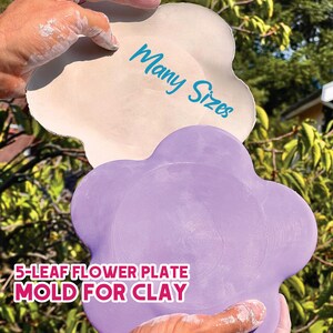 May include: A light beige and a lavender 5-leaf flower plate mold for clay. The light beige plate has the words "Many Sizes" in blue. The bottom plate is lavender. The text "5-LEAF FLOWER PLATE MOLD FOR CLAY" is at the bottom.