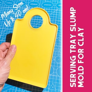 May include: A bright yellow serving tray slump mold for clay, held by a hand. The mold has a handle with a circular opening. Text on the image reads "Many Sizes Up to 40 cm!" and "SERVING TRAY SLUMP MOLD FOR CLAY."