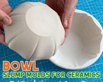 May include: Two ceramic bowl slump molds, one inverted over the other, held by hands. The molds are white and have a fluted design. Text on the blue cutting mat reads "BOWL SLUMP MOLDS FOR CERAMICS Fast Production ~ Many Sizes."
