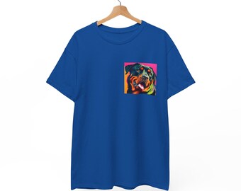 May include: Royal blue t-shirt with a colorful graphic of a Rottweiler dog on the chest pocket. The dog's portrait features vibrant colors, including pink, orange, and green, against a pink background. The shirt is hanging on a wooden hanger.
