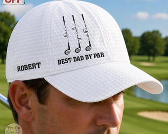 May include: White golf cap with a textured pattern. The cap features the name "Robert" on the side and the text "BEST DAD BY PAR" with golf club graphics. The names "Olivia", "Jennifer", and "William" are also printed on the cap.