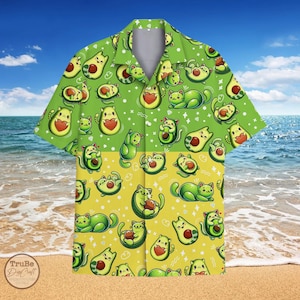 May include: A green and yellow Hawaiian shirt with a pattern of cartoon cats and avocados. The shirt has a button-up front and short sleeves.