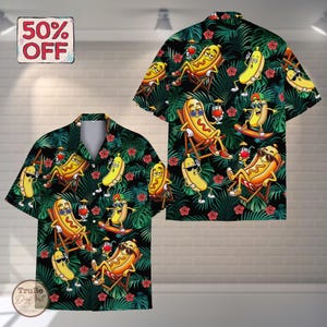 May include: Hawaiian shirt with a black background featuring a repeating pattern of cartoon hot dogs in sunglasses, relaxing on beach chairs, and skateboarding. The shirt also has tropical leaves and red flowers. A "50% OFF" sticker is in the upper left corner.