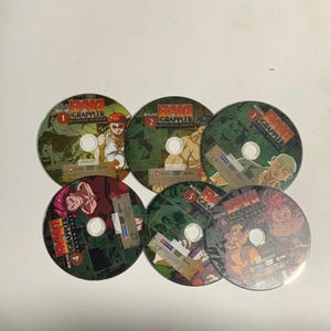 May include: Six DVDs of the anime series "Baki the Grappler." Each disc has a green and brown design with character illustrations and the series title. The discs are numbered 1 to 6.