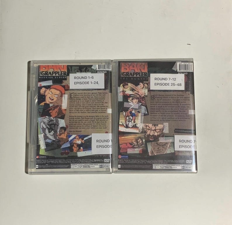 May include: Two DVD cases for the anime series "Baki the Grappler." The first case is labelled "Round 1-6, Episode 1-24." The second case is labelled "Round 7-12, Episode 25-48." Both cases feature colourful illustrations of characters.