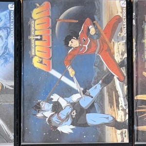 May include: Three DVD cases featuring anime artwork. The cases display the title "Golion" in yellow and orange lettering. The artwork depicts characters in action poses with a space-themed background. The cases are labeled "Collection 1", "Collection 2", and "Collection 3".