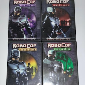 May include: Four Robocop DVD movie cases are displayed. Each case features a different title: "Meltdown", "Crashburn", "Resurrection", and "Dark Justice". The covers showcase the Robocop character in a futuristic setting, with the "Prime Directives" logo.