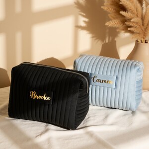 a couple of bags sitting on top of a bed