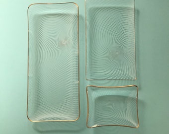 Set of 1950's glass serving plates with swirl pattern and gold trim detail