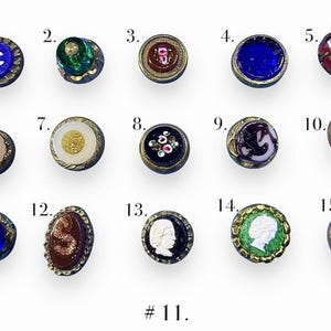 May include: A collection of fifteen antique buttons with various designs and colors. The buttons feature glass, metal, and enamel details. Some have floral patterns, cameos, or geometric shapes. The text "# 11." is at the bottom.