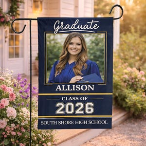 May include: A navy blue graduation garden flag with the word "Graduate" in white script. The flag features a photo of a graduate, the name "Allison", "Class of 2026", and "South Shore High School" in gold and white.