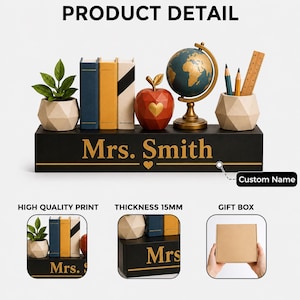 May include: A black rectangular desk organizer with the custom name Mrs. Smith printed in gold. It features a small potted plant, three book-shaped containers, a red apple with a gold heart, a globe on a stand, and a pencil holder with pencils and a ruler.