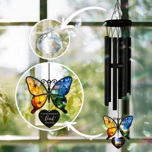 May include: A stained glass butterfly wind chime with a crystal prism and a heart-shaped tag that reads "In loving memory of Dad 1964-2024".