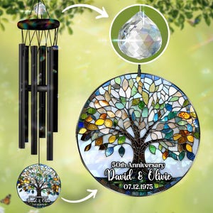 May include: A wind chime with a stained glass tree design. The round glass panel features a tree with colorful leaves and the text "50th Anniversary David & Olive 07.12.1975". A crystal prism hangs above the glass panel.