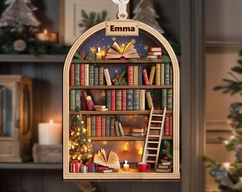May include: Wooden Christmas ornament shaped like a bookshelf, with the name "Emma" at the top. The bookshelf is filled with books, a small Christmas tree, and a ladder. The background is a starry night scene with candles.