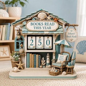 May include: A coastal-themed bookshelf tracker featuring a roof with seashells, a sign reading BOOKS READ THIS YEAR, and a flip-number counter displaying 250. It includes a miniature lighthouse, a rattan chair with a pillow reading Read, Relax, Repeat, a surfboard, and a hanging sign labeled Ethan's Book Nook.