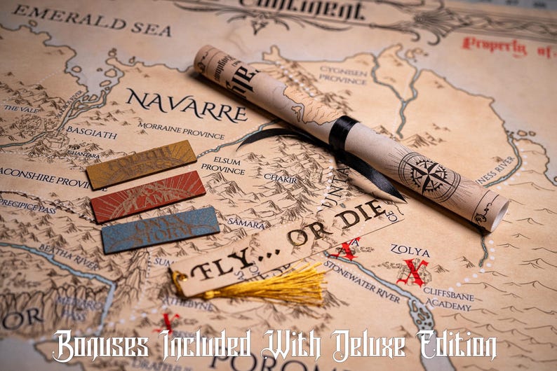 May include: A detailed map with a rolled parchment scroll, three rectangular bookmarks, and a tag with a tassel. The map features a compass rose, geographical details, and the text "FLY... OR DIE."