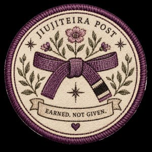May include: A circular embroidered patch with a cream background and a dark purple border. It features a purple martial arts belt tied in a knot, surrounded by floral sprigs, stars, and the text JIUJITEIRA POST and EARNED. NOT GIVEN. with a heart.