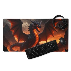 May include: A black and red dragon design mousepad with a keyboard, mouse, and headphones. The dragon has glowing red eyes and a fiery orange underbelly. The background features a mountain landscape with an orange sky.