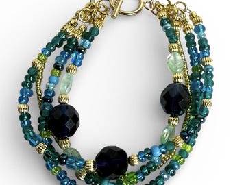 REIMAGINED Multi Strand Glass Bead Bracelet Blue Green Gold Tone Toggle Clasp