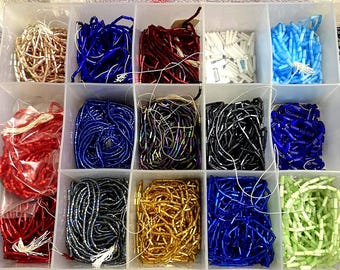 15 kinds of bugle beads.  You get what is shown.  about 1  lbs/500grams without the box. All are glass from Europe about 20 years -vintage