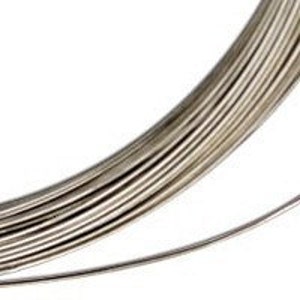 May include: A roll of silver-colored wire. The wire is thin and appears to be made of metal.