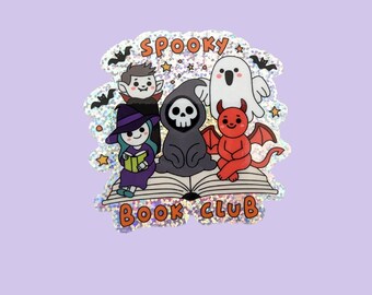 May include: A holographic sticker featuring a cartoon illustration of a spooky book club. The design includes a vampire, witch, grim reaper, ghost, and devil. The text "Spooky Book Club" is displayed above the characters.