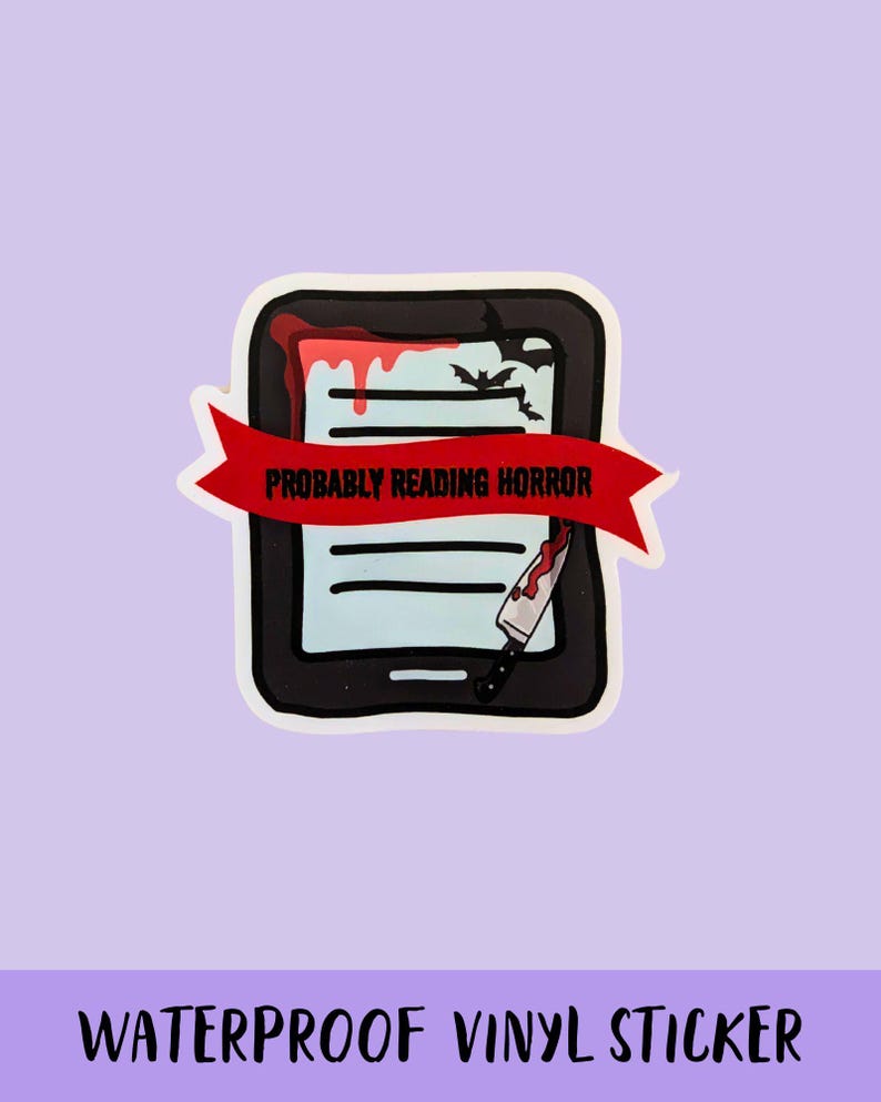 May include: A waterproof vinyl sticker featuring a black e-reader with a red banner that reads "Probably Reading Horror." The e-reader has a bloody design with a knife and bats.