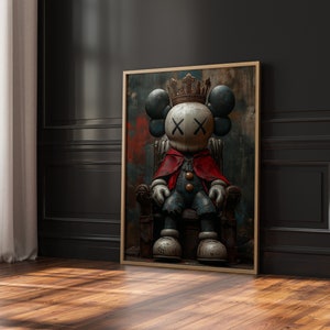 May include: A framed illustration of a cartoon character wearing a crown and sitting on a throne. The character is wearing a red cape and blue pants. The background is a dark, abstract painting.