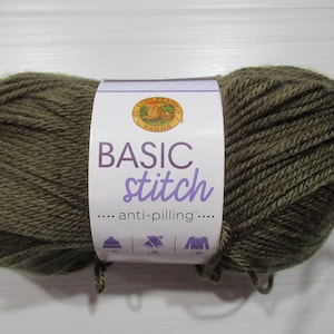 May include: A ball of olive green yarn with a white label that reads "BASIC stitch anti-pilling". The yarn is from Lion Brand Yarns. The yarn is for knitting and crochet projects.