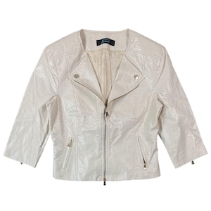 May include: Cream-coloured faux leather jacket with a textured, reptile-like pattern. The jacket features an asymmetrical zip closure, two zipped pockets, and three-quarter sleeves. The collar is a rounded, stand-up style. The label reads "Aphrodite Matthews".