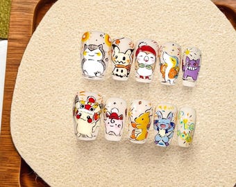 May include: A set of ten press-on nails, each adorned with a different cartoon character design. The nails feature a white base with colorful illustrations of various characters. The designs include a variety of colors and styles, creating a playful and unique aesthetic.
