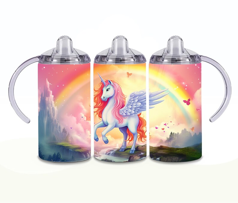 May include: A stainless steel travel mug with a clear lid and a handle. The mug features a colorful design of a unicorn with wings and a rainbow in the background.