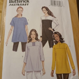 May include: A Butterick sewing pattern, B6416, featuring four tunic designs. The pattern includes illustrations of the tunics in blue, black and white, striped, and yellow. The text "FAST & EASY" is printed on the pattern.