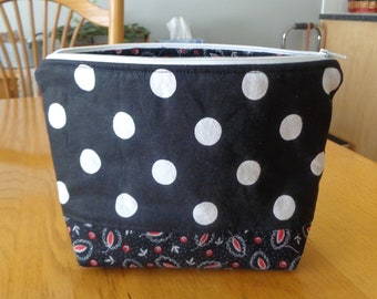 Black and white polka dot padded zipper pouch. Lined in black, red and white cotton. 9" x 6 1/2" x 2 1/2".