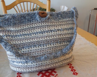 Handmade crocheted purse. Grey and tan with white lining and divided pocket in rust print. Wooden button closure.