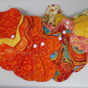 Full Starter Set 14 pads in a variety of sizes plus wet bag and drying strap. Yellow/Orange/Blue